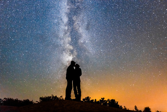 Silhouette of Couple Kissing Under Milky Way Galaxy Night Sky