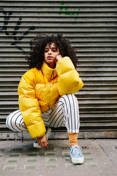 Beautiful mixed ethnicity woman wearing thick yellow puffer jacket
