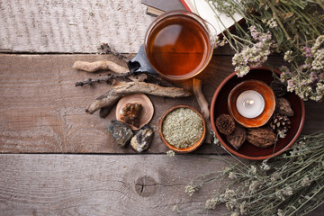 Authentic interior details, glass of herbal rea, homeopathic treatment on rustic wooden background...