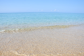 Fototapeta na wymiar Tropical beach with turquoise clear water. Summer sandy beach with a blue sea water