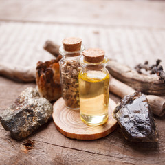 Bottles with emulsion, stones, dry herbs and wooden details. Occult, esoteric, divination and wicca concept. Mystic, old apothecary and vintage background
