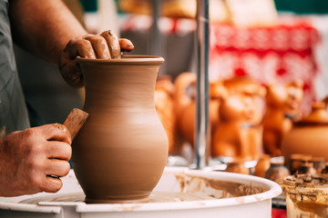 Fototapeta na wymiar Pottery Craft Wheel Ceramic Clay Potter Human Hand. Process Of C