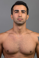 Face of young handsome Persian man shirtless