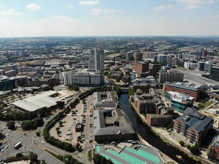 Fototapeta na wymiar Aerial photo overlooking Leeds City Center in West Yorkshire showing buildings and businesses 