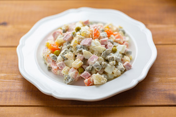 Traditional Russian salad on a wooden table