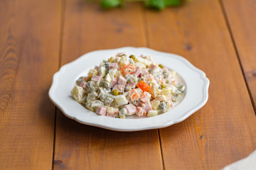 Traditional Russian salad on a wooden table