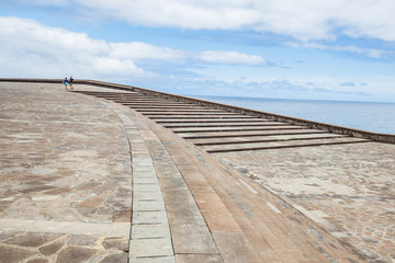 Staffage people on empty landscape with stairs.