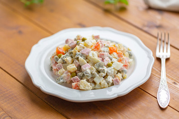 Traditional Russian salad on a wooden table