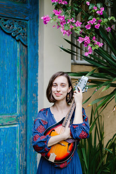 Young girl holding a ukulele