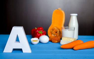Food sources of natural vitamin A and letter A. Front view. Healthy diet concept