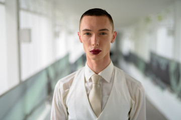 Fototapeta premium Young androgynous homosexual LGTB businessman wearing lipstick