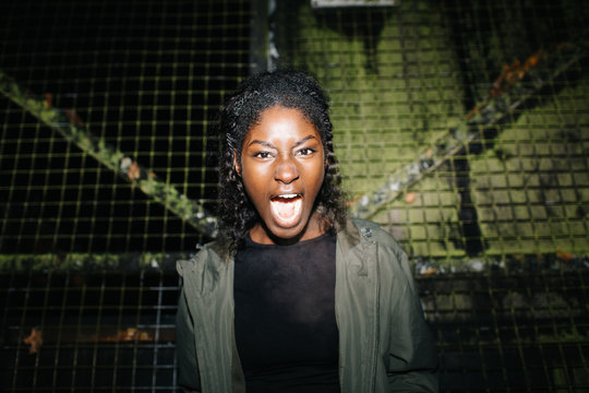 Woman screaming at metal fence