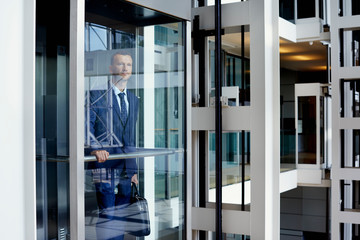 Businessman With Bag Standing In Elevator
