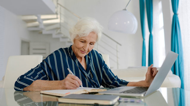 Elderly woman working from home