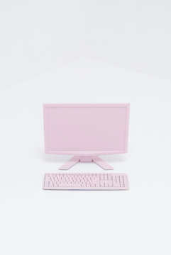 Pink PC and keyboard in white space
