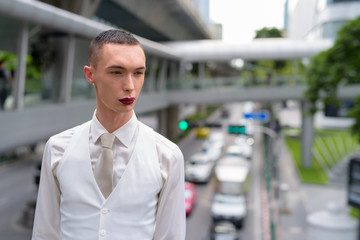 Fototapeta premium Young androgynous homosexual LGTB businessman wearing lipstick