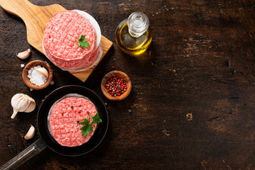 Raw Ground beef meat Burger steak cutlets  on dark wooden background.