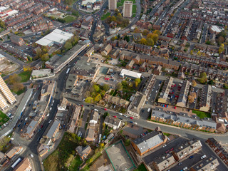 Aerial photo taken over Leeds showing houses, streets, paths and fields, taken in West Yorkshire