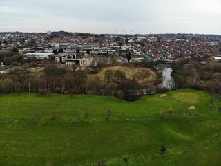 Aerial photo taken over Leeds showing houses, streets, paths and fields, taken in West Yorkshire
