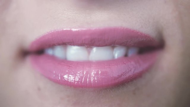 Close up of beautiful smiling sensual pink lips of young girl with open mouth and teeth. 3840x2160