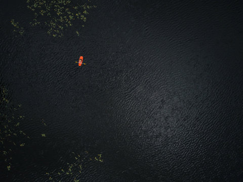 Aerial Photo of Young Boy Paddling Small Sit-On-Top Kayak Alone