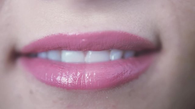 Close up of beautiful pink lips smiling of young girl with open mouth and teeth