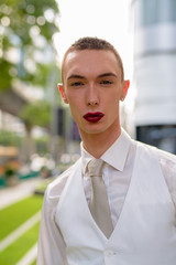 Young androgynous homosexual LGTB businessman wearing lipstick