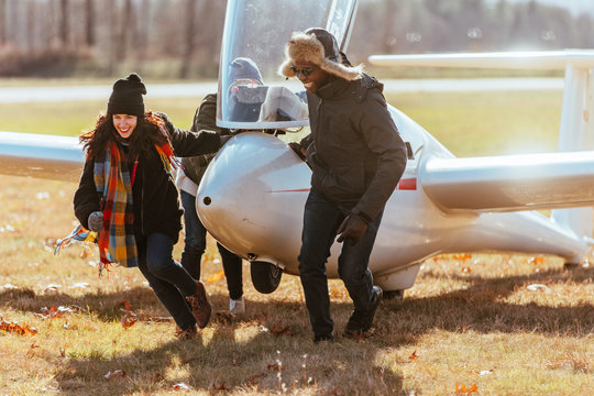 Friends pulling glider from the runway after flight