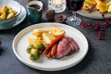 Traditional roast dinner with beef, carrots, brussel sprouts and gravy