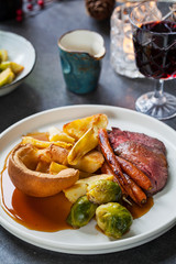 Roast dinner with beef, carrots, brussel sprouts and yorkshire pudding