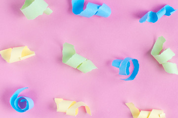Festive background. Celebration concept. Colorful party streamers on a pink background. Texture