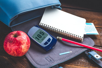 Diabetes concept. Control diabetes, monitor blood glucose levels, self control. Write blood glucose...