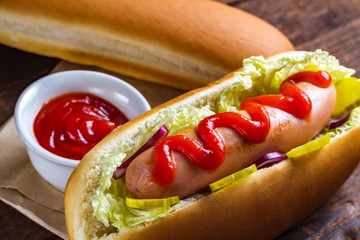 Tasty hot dog with ketchup