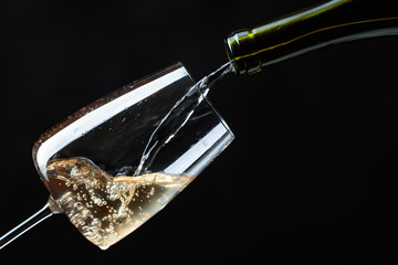 White wine being poured into wine glass.