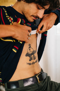 Man Showing Tattoo On Belly