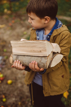 man carries wood pieces