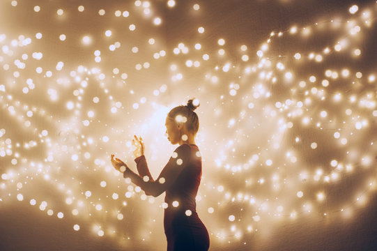 Creative image of a woman surrounded by light. Double exposure shot.