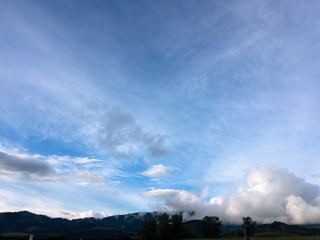 Obraz na płótnie Canvas Idyllic mountain scenery with fir trees, blue sky and clouds 