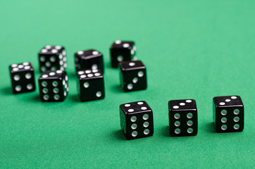 black cubes for a board game are on a green background