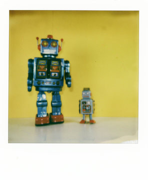Polaroid scan of two retro style robots