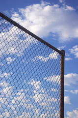 Wire mesh fence against blue sky