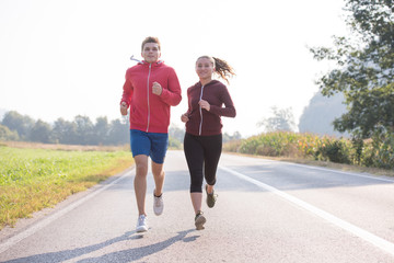 Fototapeta premium young couple jogging along a country road