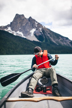 Young Adventurer Enjoying his Kayak Ride Through a Scenic Lake