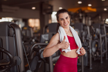 Smiling sportswoman gesturing thumb up