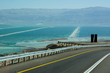 Curvy road with a view on Dead Sea at the end of a Summer day in Negev Desert