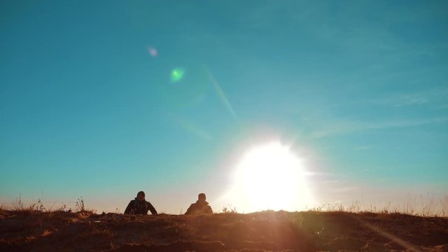 Two Tourists Jumping Happy Happiness goal achievement Nature Landscape. teamwork. two tourists hikers men and dog with backpacks walking at sunset go hiking trip. slow motion video. journey and hikers