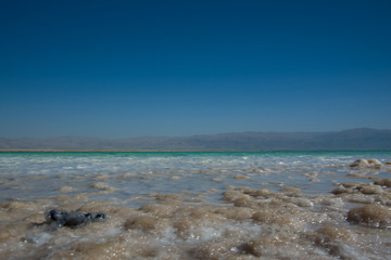 Close up view of salt crystals and mineral formation on the shore of Dead Sea in Israel, health and beauty care. Sharp surface, natural pattern