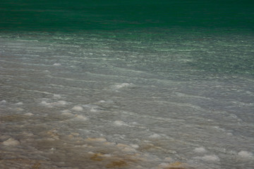 Close up view of salt crystals and mineral formation on the shore of Dead Sea in Israel, health and beauty care. Sharp surface, natural pattern