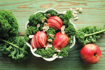 Salad with kale lettuce, apples, peanuts . Top view