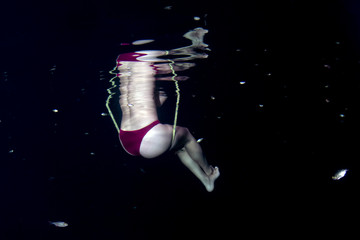 beautiful legs woman underwater on teeter totter swing